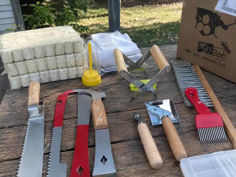 Best Beekeeping Starter Kit for Beginners: Buy Top Hive Kits 6 Beekeeping starter kit tools laid out on a wooden table before hive inspection