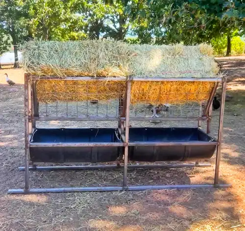 8 Best Goat Feeders: Hay, Grain, Mineral & DIY Options 8 Large homemade goat hay feeder with raised hay racks and two lower feed troughs